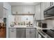 Updated kitchen featuring white cabinets and a breakfast bar at 3232 Lake Pine E Way # H2, Tarpon Springs, FL 34688
