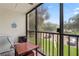 Screened lanai with table and chairs, offering a relaxing outdoor space at 3232 Lake Pine E Way # H2, Tarpon Springs, FL 34688