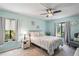 Relaxing bedroom with a ceiling fan and access to a balcony at 3232 Lake Pine E Way # H2, Tarpon Springs, FL 34688