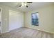 Bedroom with double door closet and large window at 1423 Meadow Lark Rd, Spring Hill, FL 34608