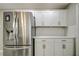 Modern kitchen with stainless steel appliances and white cabinets at 1423 Meadow Lark Rd, Spring Hill, FL 34608