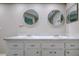 Double vanity bathroom with marble countertop and large mirrors at 1423 Meadow Lark Rd, Spring Hill, FL 34608