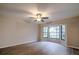 Living room with bay window, hardwood floors, and ceiling fan at 1423 Meadow Lark Rd, Spring Hill, FL 34608