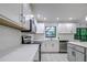 Bright kitchen with white cabinets and tile backsplash at 1423 Meadow Lark Rd, Spring Hill, FL 34608