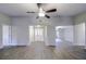 Spacious living room with wood-look floors and views of entryway at 1423 Meadow Lark Rd, Spring Hill, FL 34608