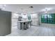 Modern kitchen with white cabinets, island, and stainless steel appliances at 1423 Meadow Lark Rd, Spring Hill, FL 34608