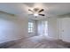 Spacious bedroom with ceiling fan and plush carpeting at 1423 Meadow Lark Rd, Spring Hill, FL 34608