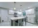 Updated kitchen featuring white cabinets, an island, and stainless steel appliances at 1423 Meadow Lark Rd, Spring Hill, FL 34608