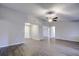 Open living room with wood-like flooring and high ceilings at 1423 Meadow Lark Rd, Spring Hill, FL 34608