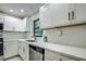 Updated kitchen featuring white cabinets, quartz countertops, and stainless steel appliances at 1423 Meadow Lark Rd, Spring Hill, FL 34608