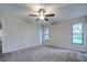 Bright bedroom with neutral walls and carpet at 1423 Meadow Lark Rd, Spring Hill, FL 34608