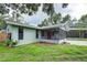 Home exterior showcasing screened porch and pool at 1423 Meadow Lark Rd, Spring Hill, FL 34608