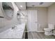 Bathroom with double vanity, marble countertop and toilet at 1423 Meadow Lark Rd, Spring Hill, FL 34608