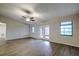 Large living room featuring wood-look flooring and ceiling fan at 1423 Meadow Lark Rd, Spring Hill, FL 34608