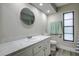 Clean bathroom with single vanity and updated flooring at 1423 Meadow Lark Rd, Spring Hill, FL 34608