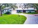 House with lush lawn and driveway at 1423 Meadow Lark Rd, Spring Hill, FL 34608