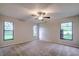 Spacious bedroom with neutral walls, ceiling fan, and ample natural light at 1423 Meadow Lark Rd, Spring Hill, FL 34608