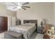 Relaxing bedroom with neutral walls, ceiling fan, plush bed, and ample furniture at 6096 Kinlock Ave, Spring Hill, FL 34608
