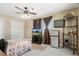 Bedroom with ceiling fan, TV, mini fridge, and storage at 6096 Kinlock Ave, Spring Hill, FL 34608
