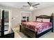 Bedroom with ceiling fan, ensuite bath, and sliding closet at 6096 Kinlock Ave, Spring Hill, FL 34608