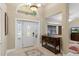 Light and bright foyer with tiled floor, an arched window and a decorative front door at 6096 Kinlock Ave, Spring Hill, FL 34608