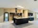 Contemporary kitchen boasting dark cabinets, granite countertops, island, and modern lighting fixtures at 6096 Kinlock Ave, Spring Hill, FL 34608
