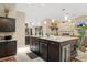 Gourmet kitchen with granite counters, stainless appliances, and center island with bar seating at 6096 Kinlock Ave, Spring Hill, FL 34608