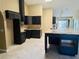 Bright kitchen with dark wood cabinetry, granite countertops and large island with seating at 6096 Kinlock Ave, Spring Hill, FL 34608