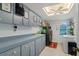 Well-organized laundry room features built-in cabinets, laundry machines, and bright skylight at 6096 Kinlock Ave, Spring Hill, FL 34608