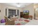 Cozy living room with a large window and TV with cabinet on a tile floor at 6096 Kinlock Ave, Spring Hill, FL 34608