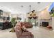 Spacious living room features stone fireplace and an open concept to the kitchen and dining area at 6096 Kinlock Ave, Spring Hill, FL 34608