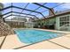 Backyard oasis featuring a large screened in pool, tanning deck, and covered patio at 6096 Kinlock Ave, Spring Hill, FL 34608