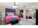Bedroom with a pink comforter and ceiling fan at 6096 Kinlock Ave, Spring Hill, FL 34608