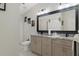 Bathroom with granite countertops, double sinks, and a large mirror at 6096 Kinlock Ave, Spring Hill, FL 34608