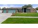 Two-story house with a three-car garage and landscaped yard at 6096 Kinlock Ave, Spring Hill, FL 34608