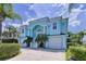 Two story light blue house with three car garage at 4260 Columbus Dr, Hernando Beach, FL 34607