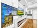 Modern fireplace with built in aquarium and large TV at 4260 Columbus Dr, Hernando Beach, FL 34607