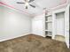 Well-lit bedroom with double door closet and carpet flooring at 4260 Columbus Dr, Hernando Beach, FL 34607