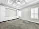 Media room with coffered ceiling and built-in cabinets at 4260 Columbus Dr, Hernando Beach, FL 34607