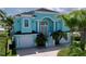 Two story home with light teal exterior and two car garage at 4260 Columbus Dr, Hernando Beach, FL 34607