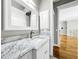 Elegant bathroom with marble vanity and white cabinets at 4260 Columbus Dr, Hernando Beach, FL 34607