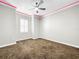 Bedroom with gray carpet, ceiling fan and window with plantation shutters at 4260 Columbus Dr, Hernando Beach, FL 34607