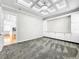 Bright bedroom with gray carpet, built-in shelving, and view into kitchen at 4260 Columbus Dr, Hernando Beach, FL 34607