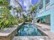 Long rectangular pool with stone coping and tropical landscaping at 4260 Columbus Dr, Hernando Beach, FL 34607