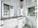 Bathroom with double vanity, farmhouse sinks, and LED mirrors at 4260 Columbus Dr, Hernando Beach, FL 34607