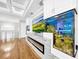 Modern fireplace with built in aquarium and large TV at 4260 Columbus Dr, Hernando Beach, FL 34607