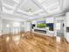 Spacious great room with hardwood floors, coffered ceiling, and fireplace at 4260 Columbus Dr, Hernando Beach, FL 34607