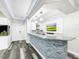 Basement bar with granite countertop, stone feature wall, and white shaker cabinets at 4260 Columbus Dr, Hernando Beach, FL 34607