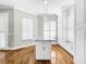Modern kitchen featuring white cabinets, marble countertops and island at 4260 Columbus Dr, Hernando Beach, FL 34607