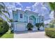 Two-story light blue house with three car garage at 4260 Columbus Dr, Hernando Beach, FL 34607